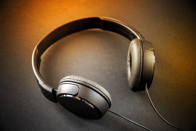 Headphones isolated on a black and orange background