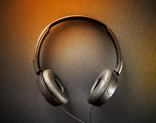 Photo headphones isolated on a black and orange background