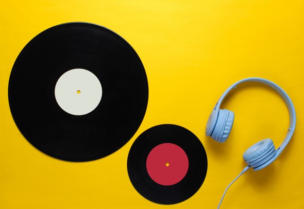 Headphones, lp records on yellow background