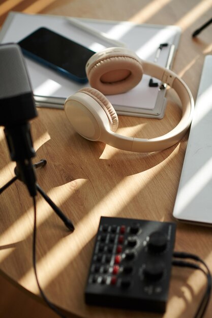 Headphones microphone and amplifier on table of podcaster view from above