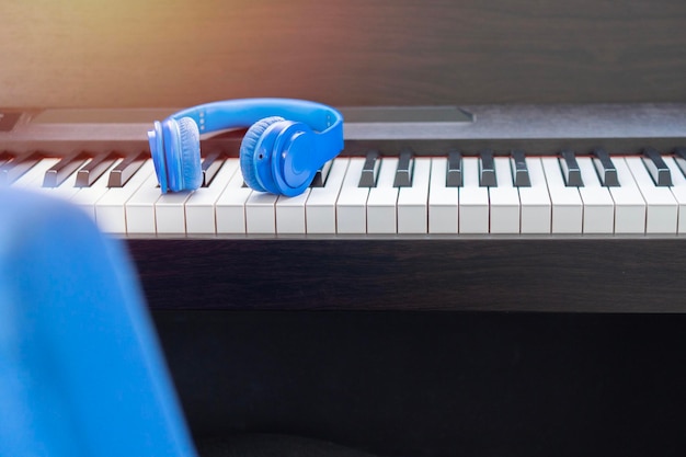 Headphones on musical synthesizer keyboard with morning light