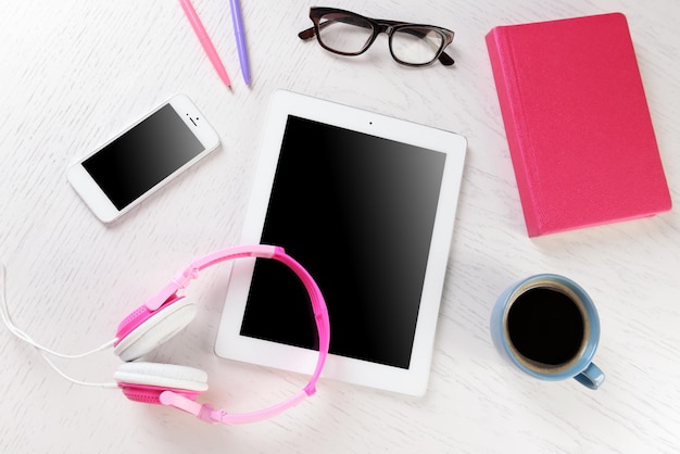 Photo headphones and other devices on worktop closeup