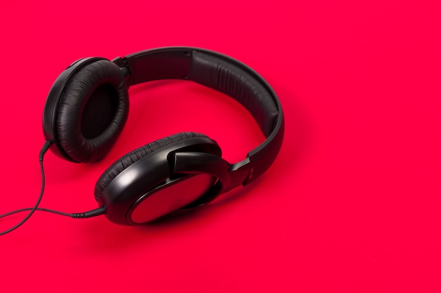 Headphones on red surface