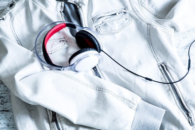 Photo headphones on a white jacket. ready to go out.