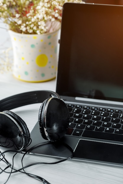 Headphones with laptop on a laptop computer keyboard