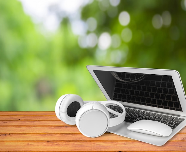 Headphones with laptop on table