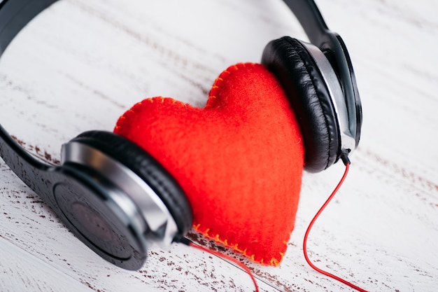 Headphones with red heart on table