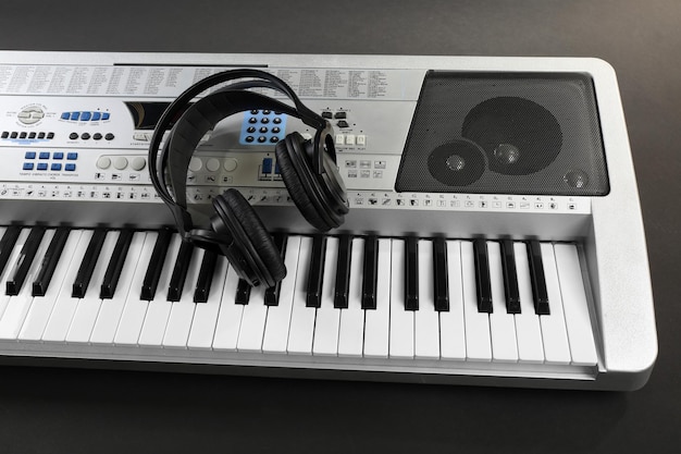 Headphones with synthesizer on gray background