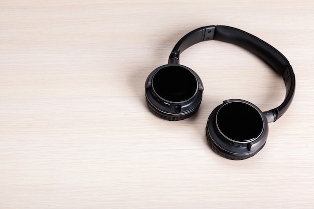 Headphones on wooden background