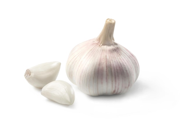 Heads of garlic with cloves of garlic placed on a white