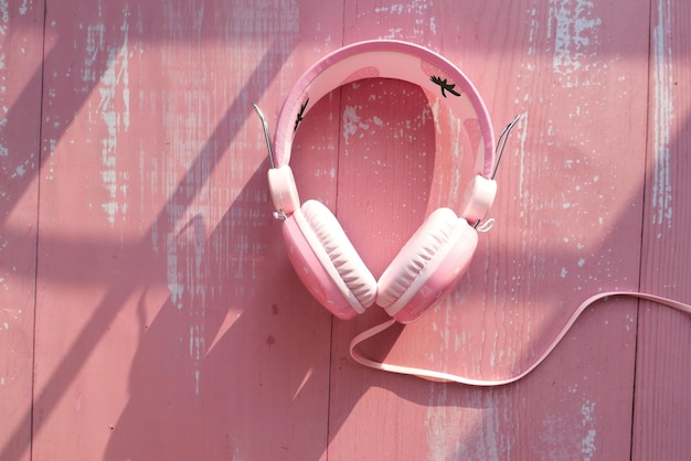 Photo headset or headphone on pink background top view