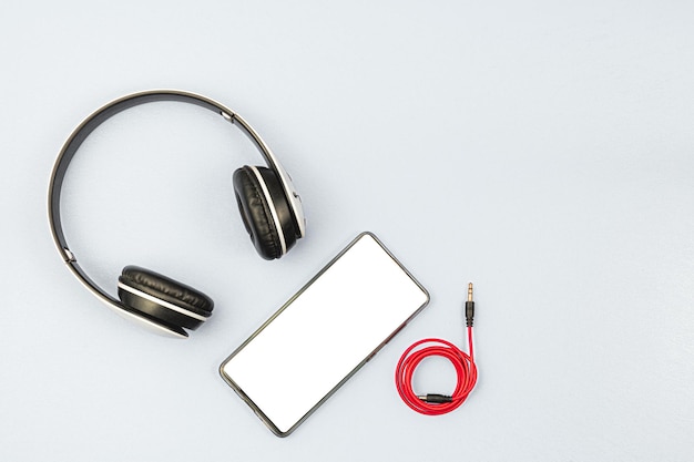 Headset and a phone on a white background Ready to listen to music