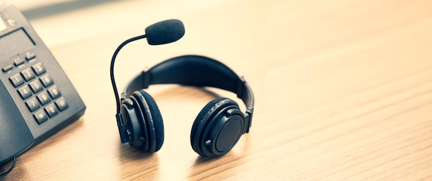 Headset and telephone on desk.