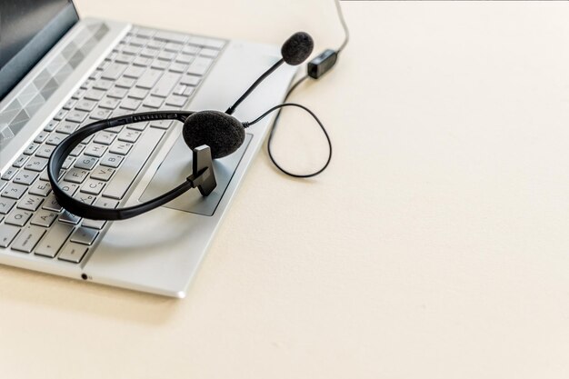 Headset with microphone on keyboard computer laptop on desktop Call center support concept