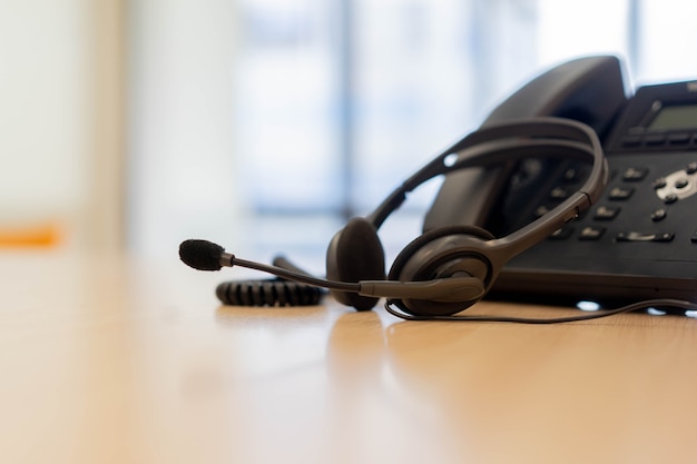 headset with telephone devices at office desk for customer service support concept