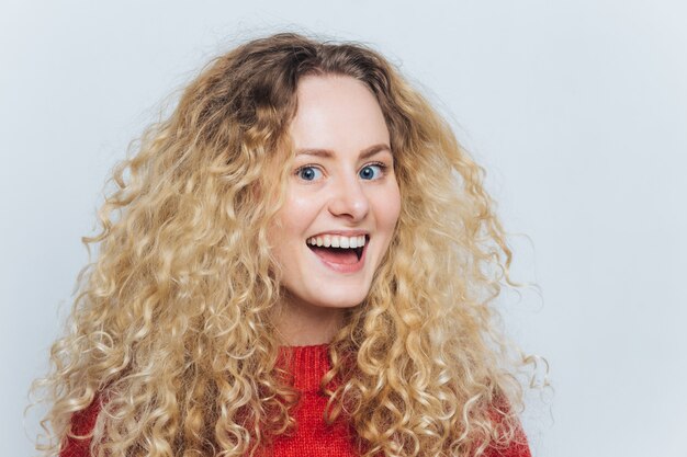 Headshot of beautiful satisfied female with pleasant joyful expression