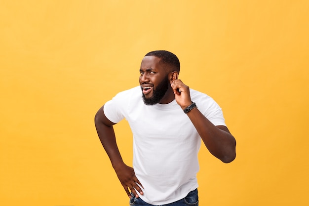 Photo headshot of goofy surprised bug-eyed young african american man   wearing casual white t-shirt staring at camera with shocked look.