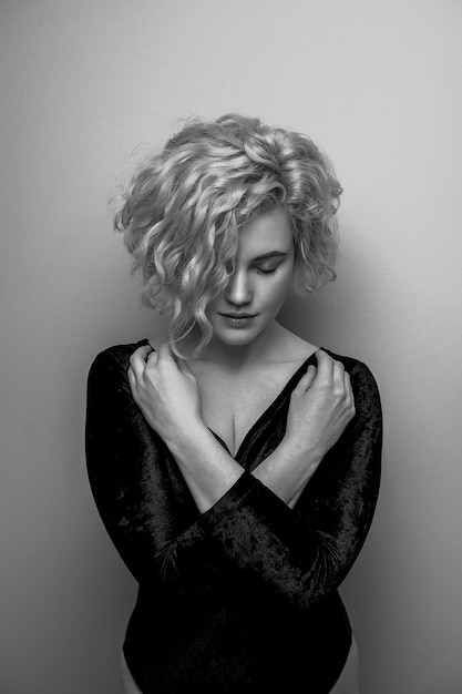 Headshot of gorgeous attractive young lady with curly hair smiling. Black and white picture. Marilyn Monroe.