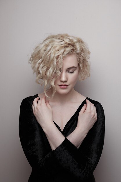 Headshot of gorgeous attractive young lady with curly hair smiling. Marilyn Monroe.