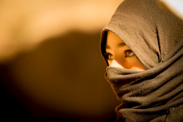 headshot of a moroccan berber girl covered with a veil