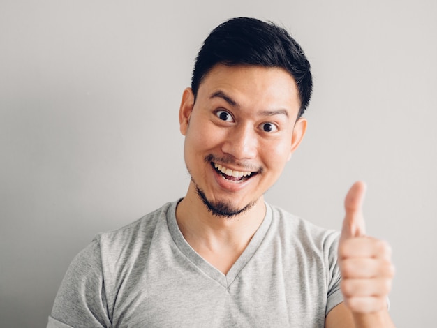 Headshot photo of Asian man with happy face. on grey background.