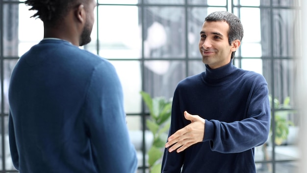 Headshot portrait of a smiling businessman offering a handshake business concept