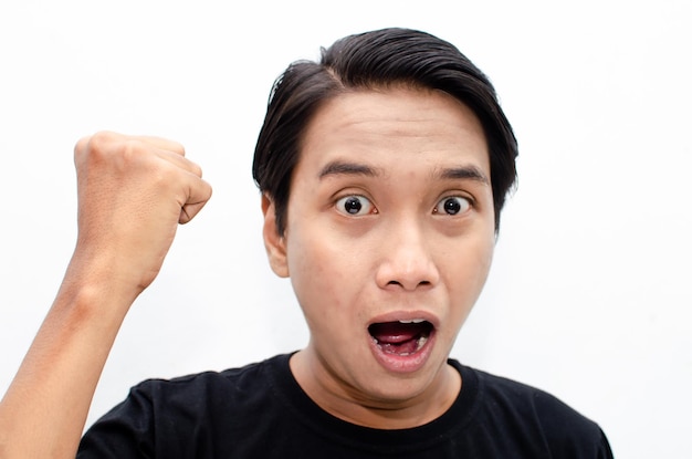 headshot of shocked, surprised, amazed young asian man in black tshirt isolated over white