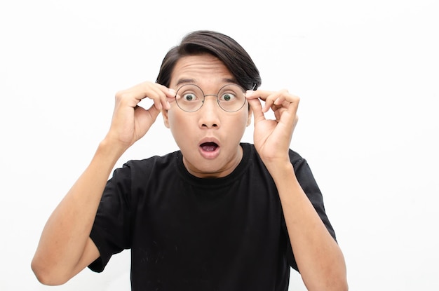 headshot of shocked, surprised, amazed young asian man in black tshirt isolated over white