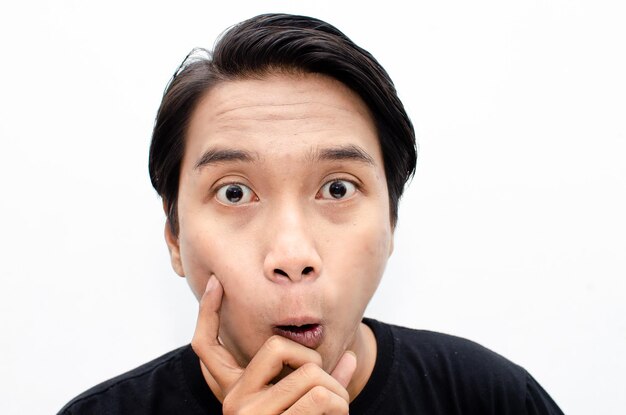 headshot of smiling, laughing, estactic young asian man in casual shirt