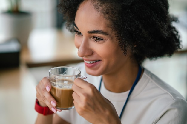 Headshot of a smiling pretty woman having coffee