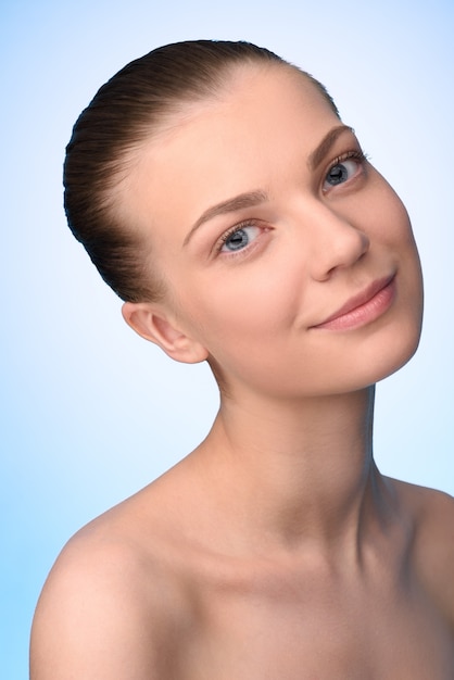 Headshot of young woman with pure skin