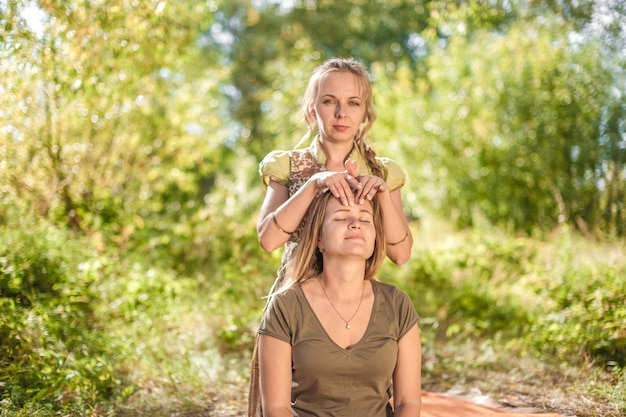 Healer provides a thorough massage in the outdoors.