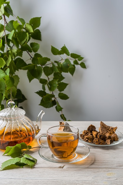 Infuso curativo di funghi di betulla con pezzi di chaga in una ciotola. caffè o tè ai funghi chaga.