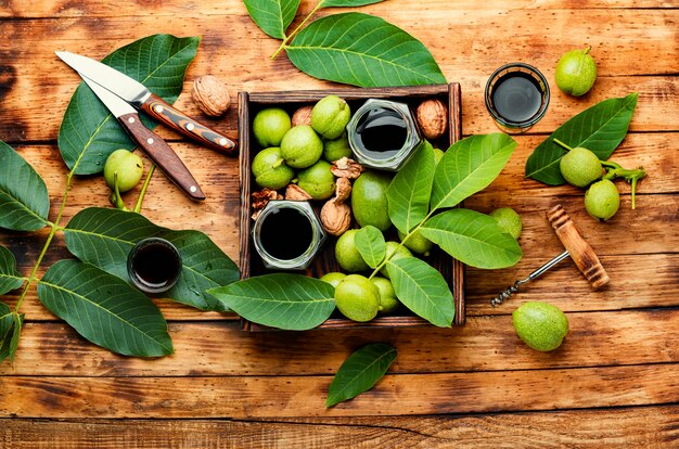 Healing tincture of unripe walnut.Green walnut in herbal medicine.