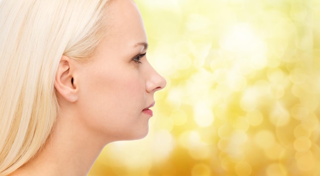 health and beauty concept - close up of clean face of beautiful young woman