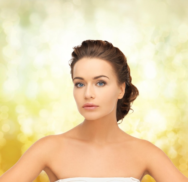 health and beauty concept - face of beautiful bride with evening updo