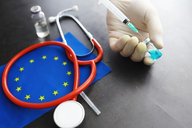 Photo health care concept eu flag and stethoscope on a gray background vaccination and epidemic