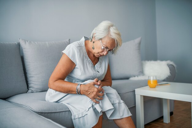 Health care concept. Woman suffering from pain in knee, closeup