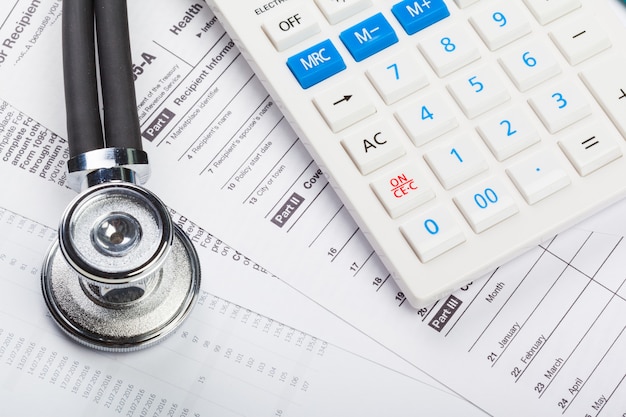 Health care costs. Stethoscope and calculator 