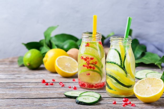 Health care, fitness, healthy nutrition diet concept. Fresh cool lemon cucumber rosemary pomegranate infused water, detox drink, lemonade in a glass jar for spring summer days.