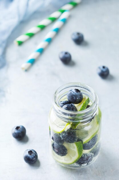 Health care fitness healthy nutrition diet concept Fresh cool lemon lime berries blueberry infused water cocktail detox drink lemonade for spring summer days