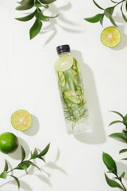 Health care fitness healthy nutrition diet concept Fresh cool lemon rosemary infused water cocktail detox drink lemonade in a glass jar Light top view flat lay background