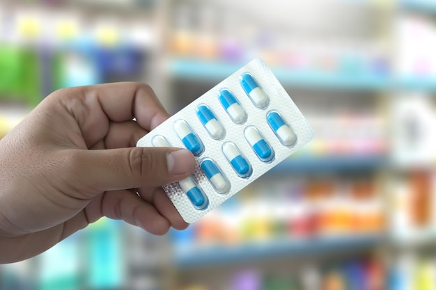 health care  holding at drugstore pack birth control pills pharmacy drugstore