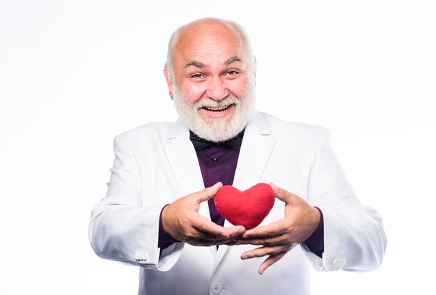 Health care Preventing heart attack Senior bald head bearded man holding red toy heart in hands Healthy life Mature man with valentines heart Heart and healthcare Diagnostics and treatment