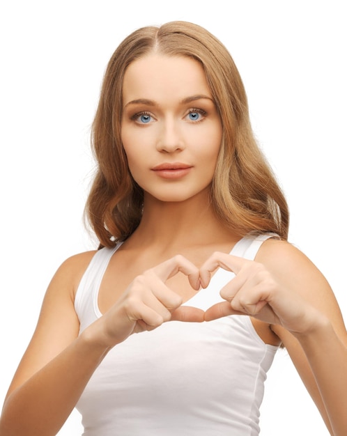 health, charity - woman in white shirt showing heart shape with hands