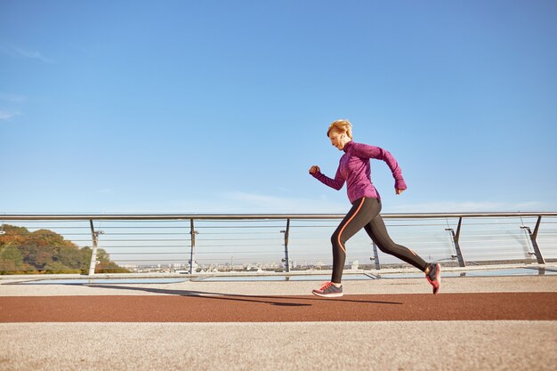 Health comes first full length shot of motivated active mature woman in sportswear running outdoors