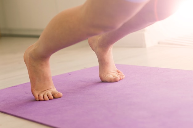 Health concept. Young beautiful woman does yoga exercise in the modern room