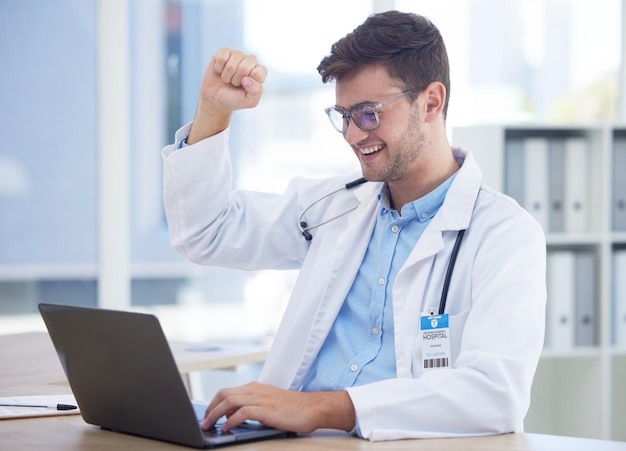 Health doctor and yes with success and winner medical achievement and man celebrate good test results on laptop Health care professional happy and winning with victory for medicine and technology