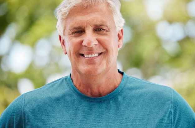 Health fitness and exercise with a senior man outdoor in summer for wellness training and enjoying retirement Workout healthy and happy with a face portrait of an elderly male athlete in nature