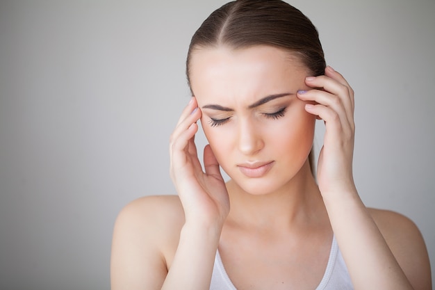 Health and Head Pain. Beautiful Woman Having Strong Headache, Feeling Pain